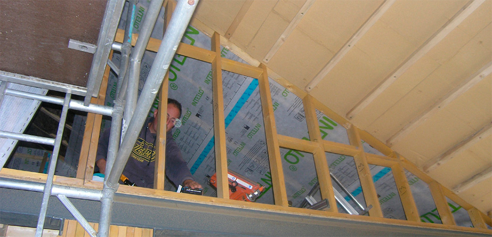 Intello vapour barrier and Gutex Ultratherm insulation fixed to underside of roof beams
