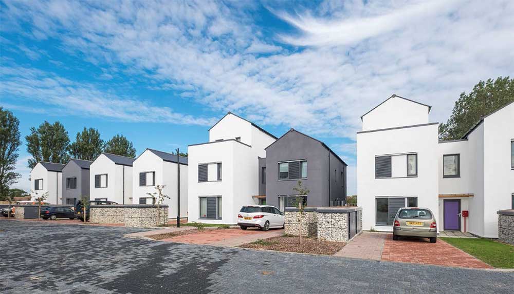 Sliding shutters were installed on the windows of the Cameron Close passive house scheme on the Isle of Wight to provide shading and reduce the risk of overheating