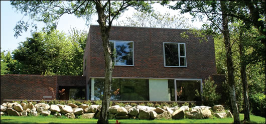 Making full use of the site's mature woodland was an important aspect of the design brief. Large windows on this rear elevation overlook the garden and wooded area out to the Wicklow mountains