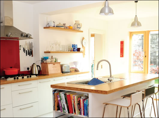 the natural light-flooded kitchen area, complete with bamboo worktops and salvaged timber flooring