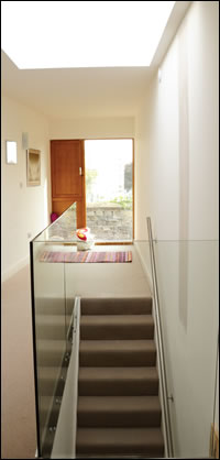 A glass balustrade helps to make the most of daylight in the extension