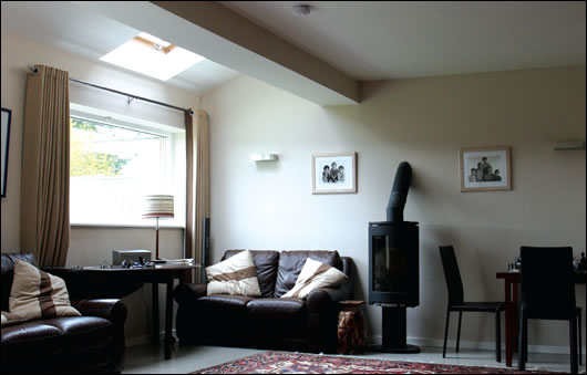 The spacious sitting room, like all of the ground floor, features underfloor heating