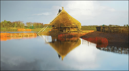 The crannog - showing its waterside position and dominant thatch roof